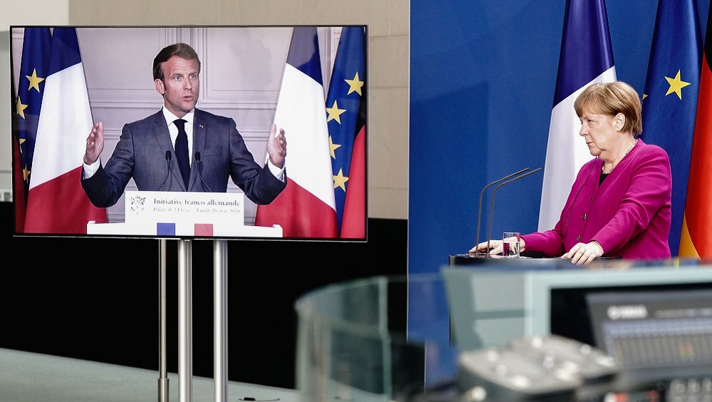 Chancellor Angela Merkel of Germany listens during a joint news conference with President Emmanuel Macron of France, who attended via video link (May 18 Getty)