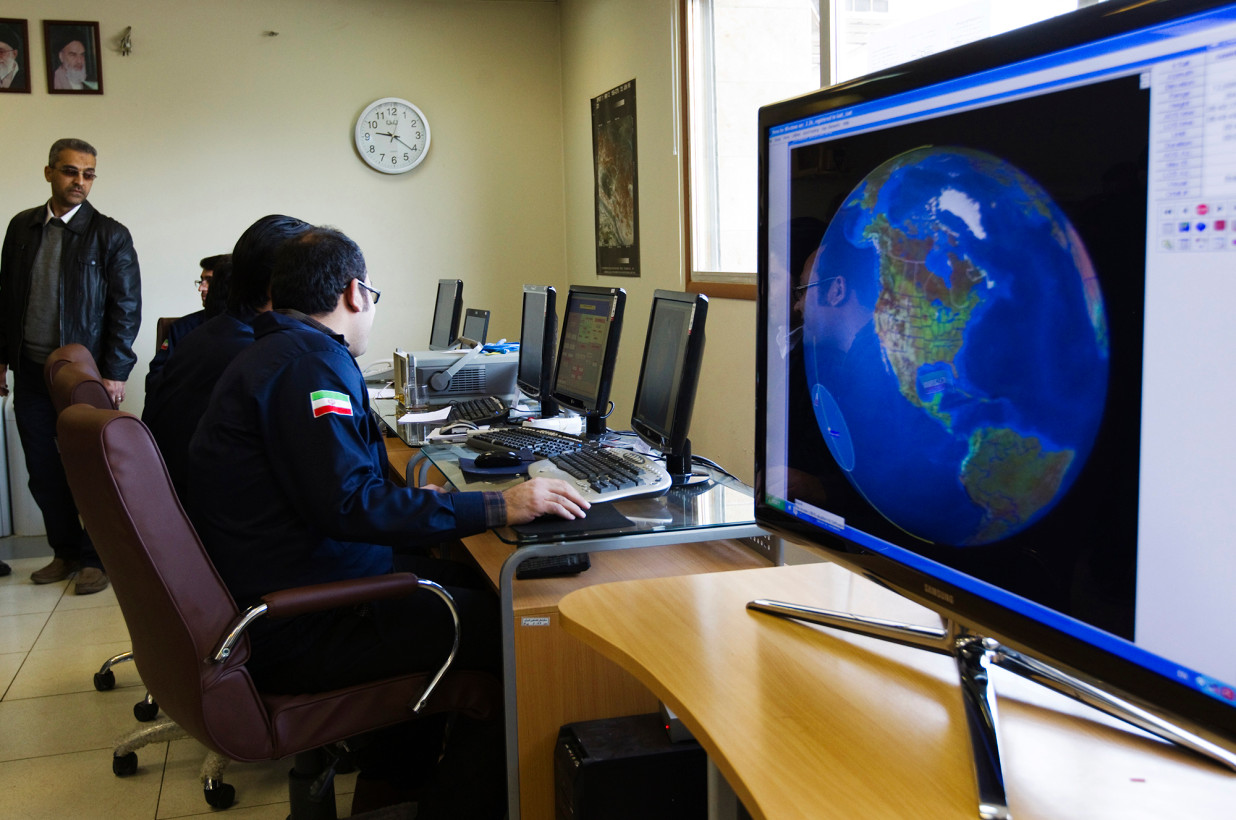 Iranian Space Agency (ISA) personnel monitor signals of the Navid-1 satellite at the facility in Mahdasht [Reuters]