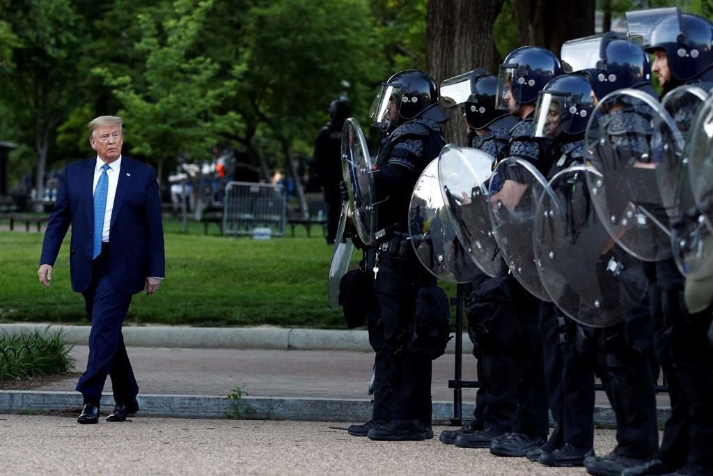 President Donald Trump walks past police in Lafayette Park after he visited outside St. John's Church across from the White House Monday, June 1, 2020 (Reuters)