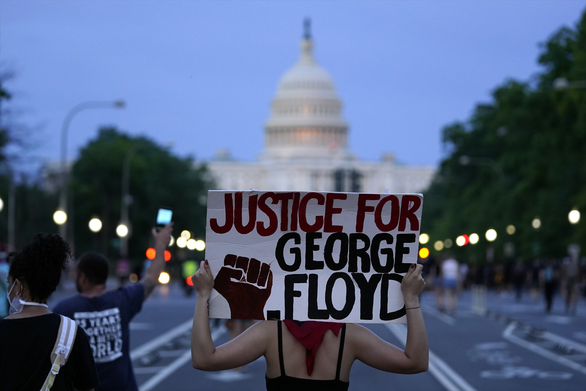 Demonstrators walk along Pennsylvania Avenue in Washington (AP)